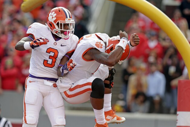 Clemson's Artavis Scott (3) and quarterback Deshaun Watson celebrate Watson's touchdown against North Carolina State during the first half of an NCAA college football game in Raleigh, N.C., Saturday, Oct. 31, 2015. Clemson won 56-41. (AP Photo/Gerry Broome)