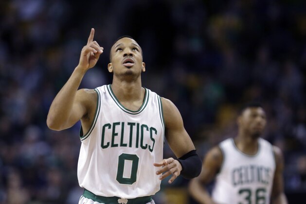 Boston Celtics guard Avery Bradley (0) points upward after scoring against the Miami Heat in the first half of an NBA basketball game in Boston, Wednesday, March 25, 2015. Celtics guard Marcus Smart (36) is in background. (AP Photo/Elise Amendola)