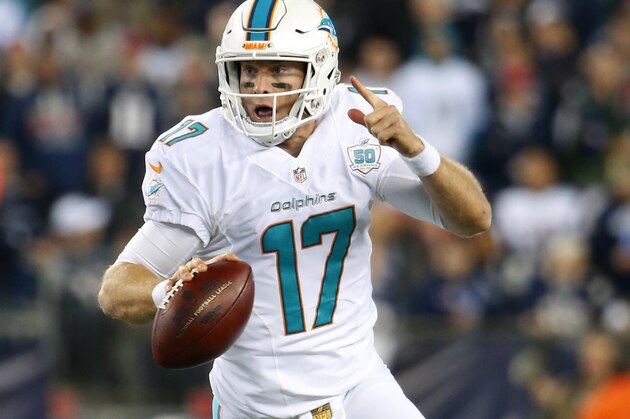 Miami Dolphins quarterback Ryan Tannehill scrambles against the New England Patriots during a NFL football game at Gillette Stadium in Foxborough, Mass. Thursday, Oct. 29, 2015. (Winslow Townson/AP Images for Panini)