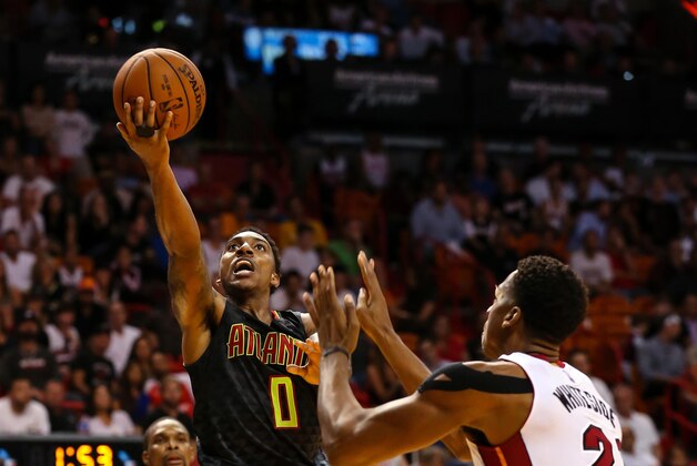 Nov 3, 2015; Miami, FL, USA; Atlanta Hawks guard Jeff Teague (0) drives to the basket as Miami Heat center Hassan Whiteside (21) looks on during the second half at American Airlines Arena. The Hawks won 98-92. Mandatory Credit: Steve Mitchell-USA TODAY Sports