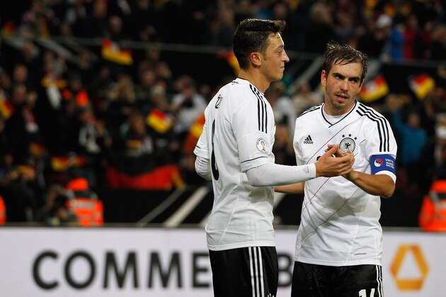 COLOGNE, GERMANY - OCTOBER 11:  Mesut Oezil (L) of Germany celebrates after scoring his team's third goal during the FIFA 2014 World Cup qualifier group C match between Germany and Republic of Ireland at RheinEnergieStadion on October 11, 2013 in Cologne, Germany.  (Photo by Boris Streubel/Getty Images)
