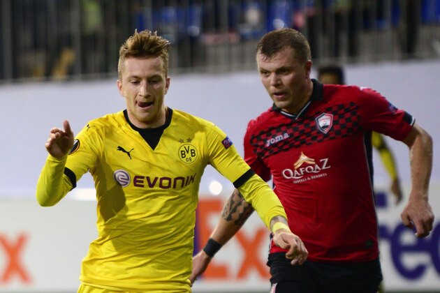 Dortmund's striker Marco Reus (L) vies for the ball with Qabala's midfielder Olexiy Gai during the UEFA Europa League group C football match between Qabala FK and Borussia Dortmund in Baku on October 22, 2015. AFP PHOTO / TOFIK BABAYEV        (Photo credit should read TOFIK BABAYEV/AFP/Getty Images)