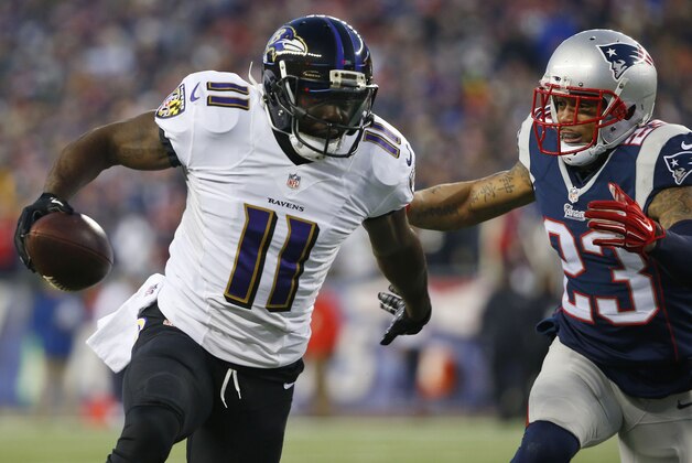 Jan 10, 2015; Foxborough, MA, USA; Baltimore Ravens wide receiver Kamar Aiken (11) carries the ball to score a touchdown as New England Patriots strong safety Patrick Chung (23) defends in the first quarter during the 2014 AFC Divisional playoff football game at Gillette Stadium. Mandatory Credit: Winslow Townson-USA TODAY Sports