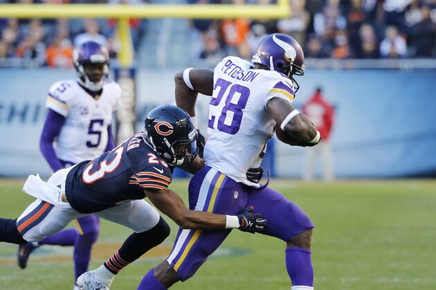 Chicago Bears cornerback Kyle Fuller (23) tackles Minnesota Vikings running back Adrian Peterson (28) during the second half of an NFL football game, Sunday, Nov. 1, 2015, in Chicago. The Vikings won 23-20. (AP Photo/Charles Rex Arbogast)