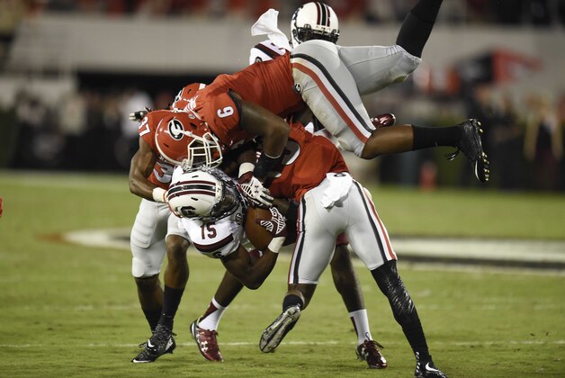 Sep 19, 2015; Athens, GA, USA; South Carolina Gamecocks wide receiver Matrick Belton (15) is tackled by Georgia Bulldogs linebacker Natrez Patrick (6) and cornerback Reggie Wilkerson (9) during the second half at Sanford Stadium. Georgia defeated South Carolina 52-20. Mandatory Credit: Dale Zanine-USA TODAY Sports