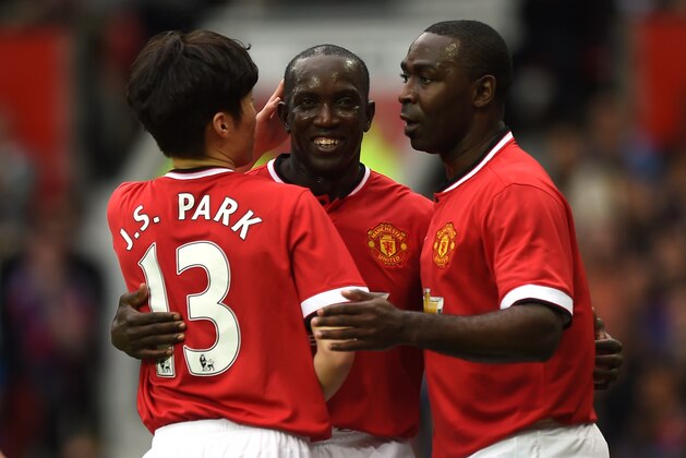 Manchester Utd legend Park Ji-Sung (L) and Manchester Utd legend Andy Cole (R) congratulate Manchester Utd legend Dwight Yorke (C) after Yorke scored United's second goal during the friendly football match between Manchester United's Legends and Bayern Munich All Stars at Old Trafford in Manchester, northwest England, on June 14, 2015. The charity friendly football match reuniting former Manchester United stars with legends from Bayern Munich was played in aid of the Manchester United Foundation. AFP PHOTO / PAUL ELLIS (Photo credit should read PAUL ELLIS/AFP/Getty Images) Manchester Utd legend Park Ji-Sung (L) and Manchester Utd legend Andy Cole (R) congratulate Manchester Utd legend Dwight Yorke (C) after Yorke scored United's second goal during the friendly football match between Manchester United's Legends and Bayern Munich All Stars at Old Trafford in Manchester, northwest England, on June 14, 2015. The charity friendly football match reuniting former Manchester United stars with legends from Bayern Munich was played in aid of the Manchester United Foundation. AFP PHOTO / PAUL ELLIS (Photo credit should read PAUL ELLIS/AFP/Getty Images)