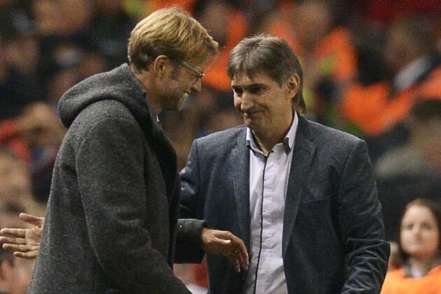 Liverpool's German manager  Jurgen Klopp (L) shakes hands with Rubin Kazan's Russian manager Valeri Chaly after a   UEFA Europa League group B football match between Liverpool FC and FC Rubin Kazan at Anfield in Liverpool, north west England, on October 22, 2015.  AFP PHOTO / OLI SCARFF        (Photo credit should read OLI SCARFF/AFP/Getty Images)