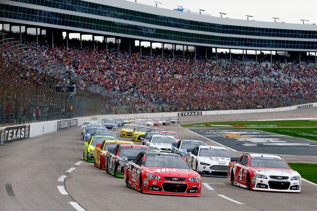FORT WORTH, TX - APRIL 11:  Kurt Busch, driver of the #41 Haas Automation Chevrolet, and Kevin Harvick, driver of the #4 Budweiser/Jimmy John's Chevrolet, lead the field to the green flag for the running of the NASCAR Sprint Cup Series Duck Commander 500 at Texas Motor Speedway on April 11, 2015 in Fort Worth, Texas.  (Photo by Tom Pennington/Getty Images for Texas Motor Speedway)