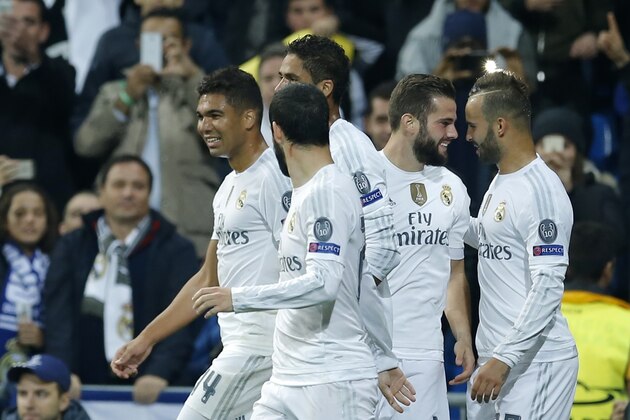 Real Madrid's Nacho Fernandez, second right, celebrates with his teammate Jese Rodriguez, right, after scoring the opening goal of his team during the Champions League group A soccer match between Real Madrid and PSG at the Santiago Bernabeu stadium in Madrid, Tuesday, Nov. 3, 2015. (AP Photo/Francisco Seco)