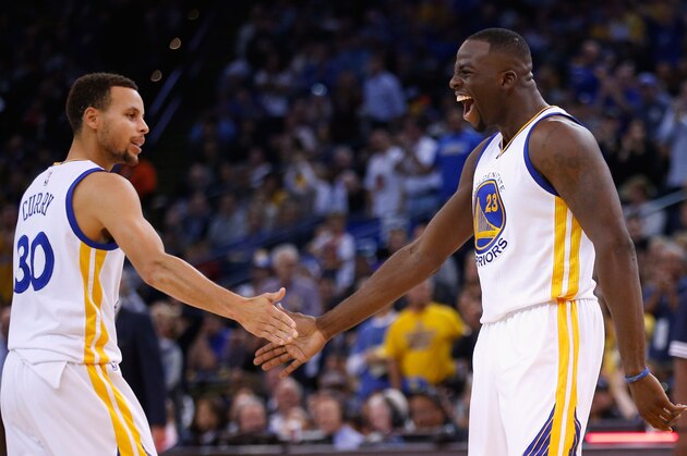 OAKLAND, CA - NOVEMBER 02:  Draymond Green #23 of the Golden State Warriors is congratulated by Stephen Curry #30 after he made a shot against the Memphis Grizzlies at ORACLE Arena on November 2, 2015 in Oakland, California. NOTE TO USER: User expressly acknowledges and agrees that, by downloading and or using this photograph, User is consenting to the terms and conditions of the Getty Images License Agreement.  (Photo by Ezra Shaw/Getty Images)
