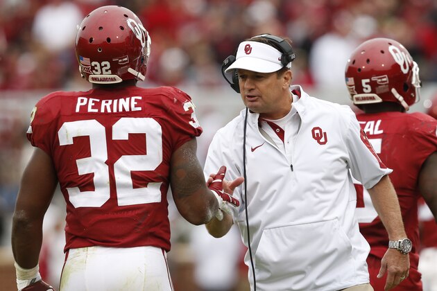 Oklahoma head coach Bob Stoops, front right, greets running back Samaje Perine (32) who returns to the bench following a touchdown in the second quarter of an NCAA college football game against Texas Tech in Norman, Okla., Saturday, Oct. 24, 2015. (AP Photo/Sue Ogrocki)