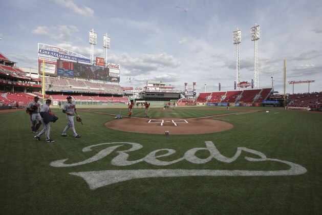 Workers prepare the field at Great American Ballpark for a baseball game between the Cincinnati Reds and the Atlanta Braves, Tuesday, May 12, 2015, in Cincinnati. (AP Photo/John Minchillo)