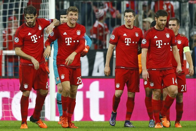 Bayern's Thomas Mueller, second from left, celebrates after scoring his side's second goal during the Champions League Group F soccer match between Bayern Munich and Arsenal FC in Munich, southern Germany, Wednesday, Nov. 4, 2015. (AP Photo/Matthias Schrader)
