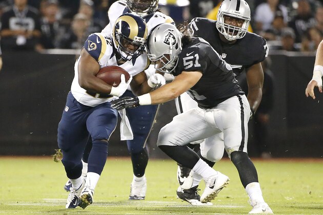 Oakland Raiders inside linebacker Ben Heeney (51) tackles St. Louis Rams running back Trey Watts (42) during the first half of an NFL preseason football game in Oakland, Calif., Friday, Aug. 14, 2015. (AP Photo/Tony Avelar)