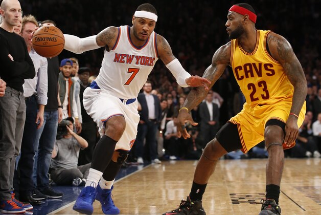 New York Knicks forward Carmelo Anthony (7) drives past Cleveland Cavaliers forward LeBron James (23) in the second half of an NBA basketball game at Madison Square Garden in New York, Thursday, Dec. 4, 2014. The Cavaliers defeated the Knicks 90-87. (AP Photo/Kathy Willens)