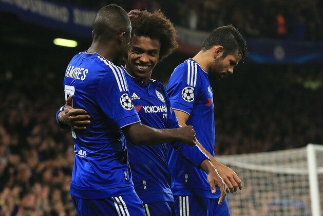 Chelsea's Willian, center, celebrates with Ramires, left, and Diego Costa after scoring the winning goal during the Champions League Group G soccer match between Chelsea and Dynamo Kiev at Stamford Bridge Stadium in London,  Wednesday, Nov. 4, 2015. (AP Photo/Tim Ireland)