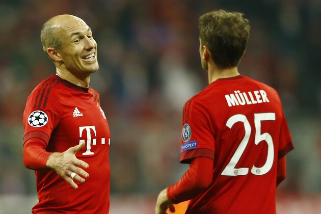 Bayern's Arjen Robben, left, celebrates with Thomas Mueller after Bayern won 5-1 during the Champions League Group F soccer match between Bayern Munich and Arsenal FC in Munich, southern Germany, Wednesday, Nov. 4, 2015. (AP Photo/Matthias Schrader)