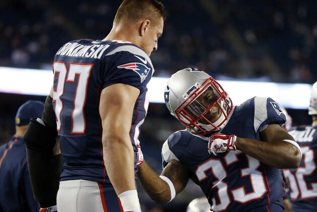 New England Patriots running back Dion Lewis (33) warms up with tight end Rob Gronkowski (87) before an NFL football game against the Miami Dolphins, Thursday, Oct. 29, 2015, in Foxborough, Mass. (AP Photo/Michael Dwyer)