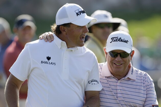 Phil Mickelson, left, walks with Butch Harmon during a practice round for the 91st PGA Championship at the Hazeltine National Golf Club in Chaska, Minn., Wednesday, Aug. 12, 2009. (AP Photo/Charles Neibergall)