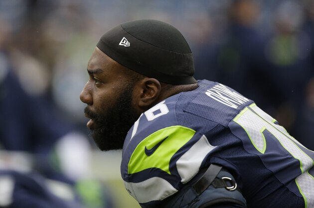 Seattle Seahawks tackle Russell Okung stretches on the field before an NFL football game against the Carolina Panthers, Sunday, Oct. 18, 2015, in Seattle. (AP Photo/Elaine Thompson)