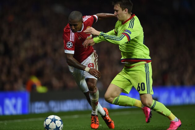 Manchester United's English midfielder Ashley Young (L) vies with CSKA Moscow's defender Aleksandr Golovin during a UEFA Chamions league group stage football match between CSKA Moscow and Manchester United at Old Trafford in Manchester, north west England on November 3, 2015. AFP PHOTO/PAUL ELLIS        (Photo credit should read PAUL ELLIS/AFP/Getty Images)
