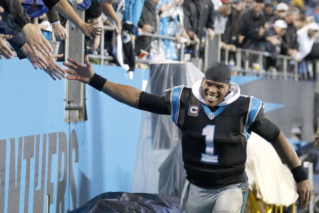 Carolina Panthers' Cam Newton (1) celebrates a 7-0 start with fans following an NFL football game against the Indianapolis Colts in Charlotte, N.C., Monday, Nov. 2, 2015. The Panthers won in overtime 29-26. (AP Photo/Bob Leverone)