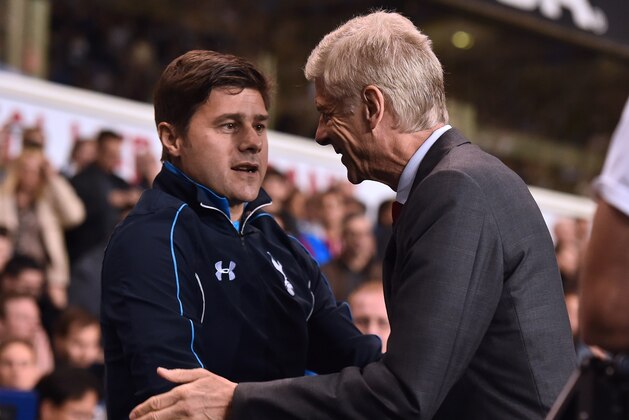 Arsenal's French manager Arsene Wenger greets Tottenham Hotspur's Argentinian Head Coach Mauricio Pochettino (L) ahead of the English League Cup third round football match between Tottenham Hotspur and Arsenal at White Hart Lane in north London on September 23, 2015. AFP PHOTO / BEN STANSALL

RESTRICTED TO EDITORIAL USE. No use with unauthorized audio, video, data, fixture lists, club/league logos or 'live' services. Online in-match use limited to 75 images, no video emulation. No use in betting, games or single club/league/player publications.        (Photo credit should read BEN STANSALL/AFP/Getty Images)