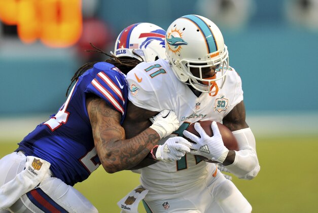 Sep 27, 2015; Miami Gardens, FL, USA; Miami Dolphins wide receiver DeVante Parker (11) is tackled by Buffalo Bills cornerback Stephon Gilmore (24) during the second half at Sun Life Stadium. Mandatory Credit: Steve Mitchell-USA TODAY Sports