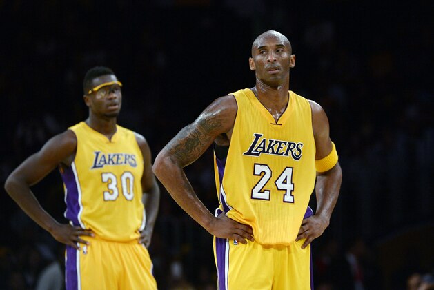 LOS ANGELES CA - NOVEMBER 3: Kobe Bryant #24 and Julius Randle #30 of the Los Angeles Lakers during a break in the action against Denver Nuggets in the fourth quarter of the basketball game at Staples Center November 3, 2015, in Los Angeles California. Lakers lost to the Nuggets, 120-109. NOTE TO USER: User expressly acknowledges and agrees that, by downloading and or using this photograph, User is consenting to the terms and conditions of the Getty Images License Agreement. (Photo by Kevork Djansezian/Getty Images)