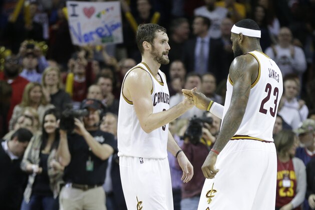 Cleveland Cavaliers' Kevin Love and LeBron James (23) celebrate after a 97-88 win over the Charlotte Hornets in an NBA basketball game Monday, Dec. 15, 2014, in Cleveland. (AP Photo/Mark Duncan)