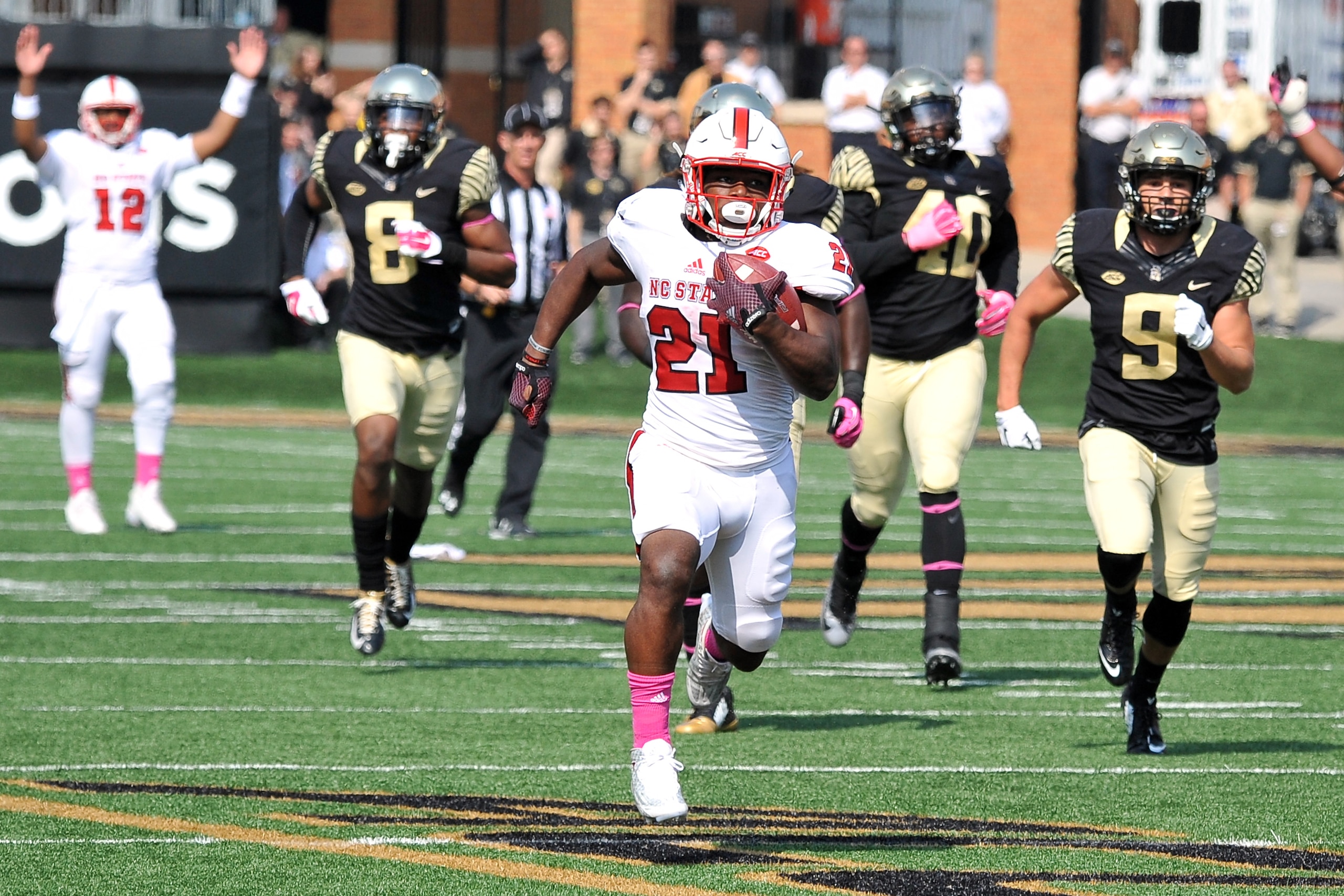 WINSTON-SALEM, NC - OCTOBER 24: Matthew Dayes #21 of the North Carolina State Wolfpack runs for a 57-yard touchdown against the Wake Forest Demon Deacons at BB&T Field on October 24, 2015 in Winston-Salem, North Carolina. NC State defeated Wake Forest 35-17. (Photo by Lance King/Getty Images)
