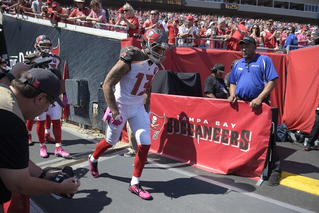 Tampa Bay Buccaneers wide receiver Mike Evans (13) runs onto the field during player introductions before an NFL football game against the Jacksonville Jaguars in Tampa, Fla., Sunday, Oct. 11, 2015. (AP Photo/Phelan M. Ebenhack)