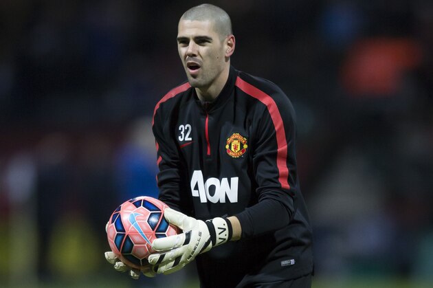 Manchester United's substitute goalkeeper Victor Valdes warms up before the English FA Cup Fifth Round soccer match between Preston and Manchester United at Deepdale Stadium in Preston, England, Monday, Feb. 16, 2015.  (AP Photo/Jon Super)
