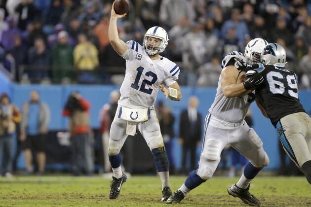 Indianapolis Colts' Andrew Luck (12) makes a pass against the Carolina Panthers' defense in the second half of an NFL football game in Charlotte, N.C., Monday, Nov. 2, 2015. The Panthers won in overtime 29-26. (AP Photo/Bob Leverone)