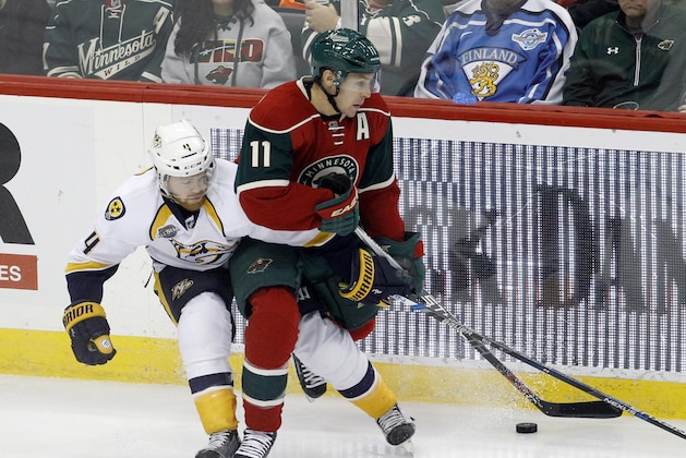 Minnesota Wild left wing Zach Parise, right, and Nashville Predators defenseman Ryan Ellis, left, battle for the puck during the first period of an NHL hockey game in St. Paul, Minn., Thursday, Nov. 5, 2015. (AP Photo/Ann Heisenfelt)