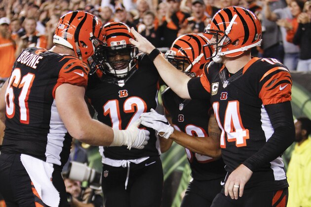 Cincinnati Bengals wide receiver Mohamed Sanu (12) celebrates after scoring a touchdown with center Russell Bodine (61) and quarterback Andy Dalton (14) during the second half of an NFL football game against the Cleveland Browns, Thursday, Nov. 5, 2015, in Cincinnati. (AP Photo/Frank Victores)