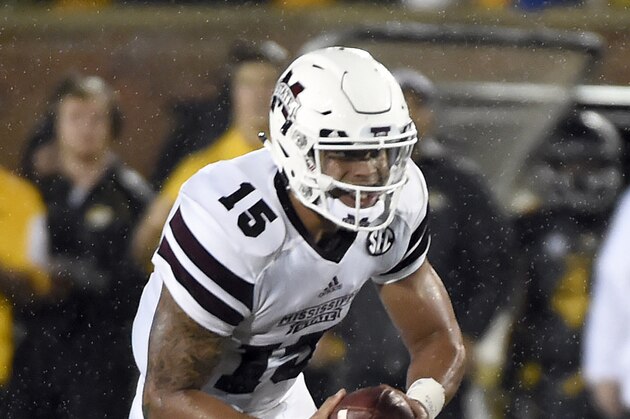 Mississippi State quarterback Dak Prescott (15) runs with the ball past Missouri linebacker Kentrell Brothers during the first half of an NCAA college football game on Thursday, Nov. 5, 2015, in Columbia, Mo. (AP Photo/L.G Patterson)