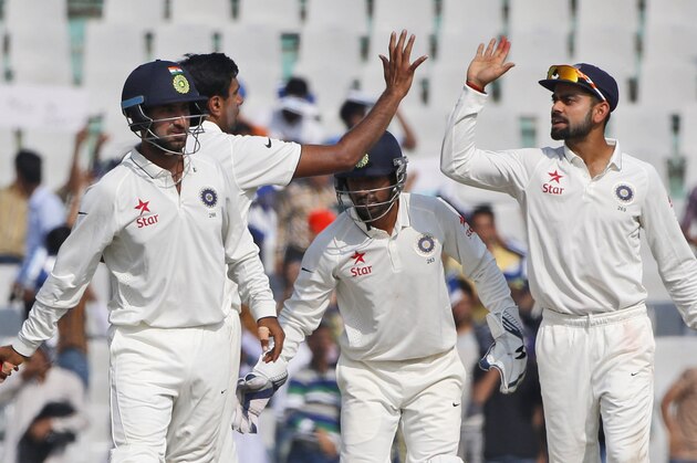 Indian cricket captain Virat Kohli, right, celebrates with teammate Ravichandran Ashwin the dismissal of South Africa's Imran Tahir during the second day of their first cricket test match in Mohali, India, Friday, Nov. 6, 2015. (AP Photo /Tsering Topgyal)
