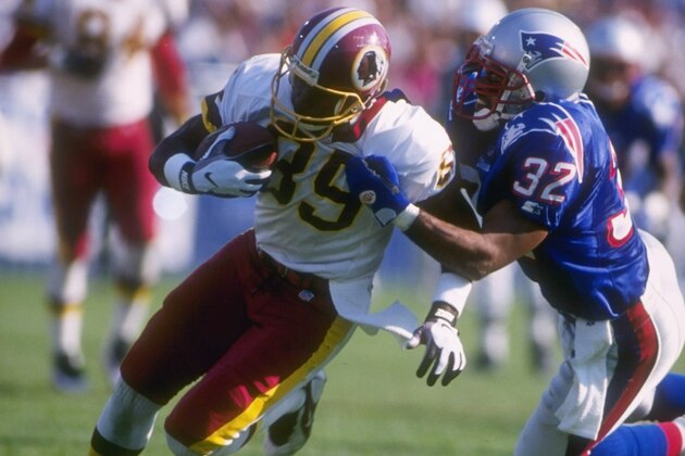 13 Oct 1996: Wide receiver Henry Ellard #89 of the Washington Redskins hangs onto the football as he attempts to run through the diving grasp of defensive back Willie Clay #32 of the New England Patriots following a recetpion in the Redskins 27-22 victory