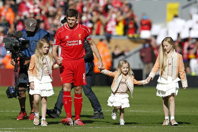Liverpool's Steven Gerrard walks on the pitch with his daughters ahead of the English Premier League soccer match between Liverpool and Crystal Palace at Anfield Stadium, Liverpool, England, Saturday, May 16, 2015. Gerard will play his final home match for Liverpool on Saturday at Anfield after over 700 appearances for the club, before he moves to MLS team LA Galaxy. (AP Photo/Jon Super)
