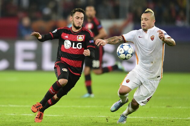 Roma's Radja Nainggolan, right, and Leverkusen's Hakan Calhanoglu challenge for the ball during the Champions League group E soccer match between Bayer 04 Leverkusen and AS Roma in Leverkusen, Germany, Tuesday, Oct. 20, 2015. (AP Photo/Sebastian Konopka)