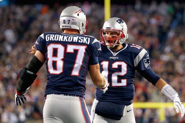 FOXBORO, MA - OCTOBER 29:  Rob Gronkowski #87 and Tom Brady #12 of the New England Patriots react after Gronkowski scored a touchdown during the first quarter against the Miami Dolphins at Gillette Stadium on October 29, 2015 in Foxboro, Massachusetts.  (Photo by Jim Rogash/Getty Images)