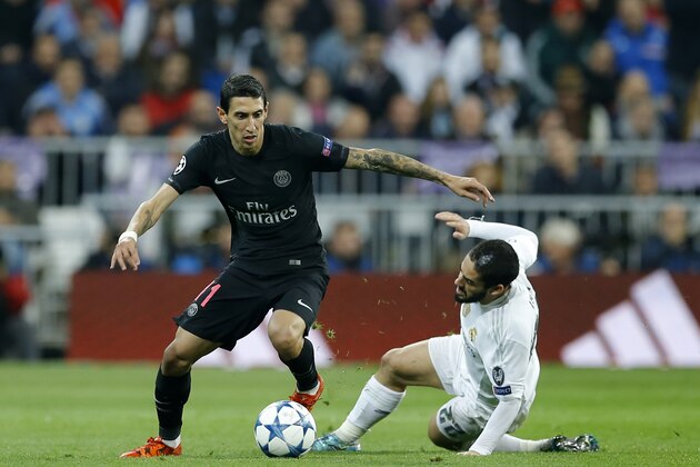 PSG's Angel Di Maria, left, keeps the ball as Real Madrid's Isco falls during the Champions League group A soccer match between Real Madrid and PSG at the Santiago Bernabeu stadium in Madrid, Tuesday, Nov. 3, 2015. (AP Photo/Francisco Seco)