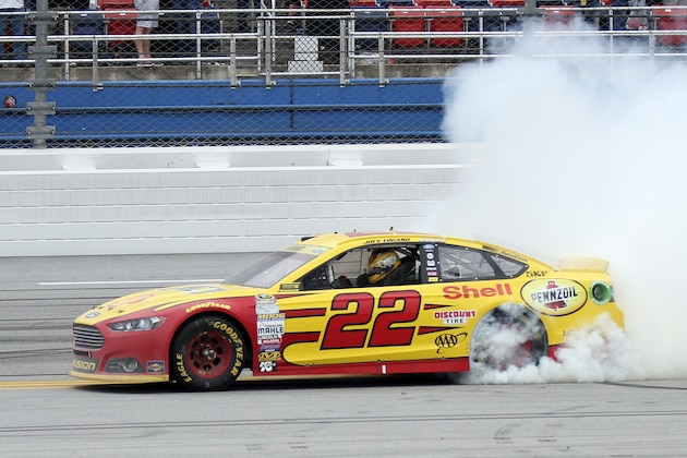 Sprint Cup Series driver Joey Logano (22) smokes his tires after winning the NASCAR Sprint Cup Series auto race at Talladega Superspeedway Sunday, Oct. 25, 2015, in Talladega, Ala. (AP Photo/Russell Norris)