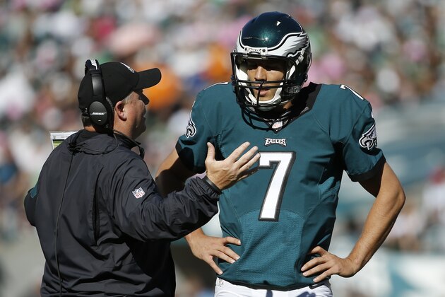 Philadelphia Eagles head coach Chip Kelly, left, talks with quarterback Sam Bradford during the second half of an NFL football game against the New Orleans Saints, Sunday, Oct. 11, 2015, in Philadelphia. (AP Photo/Michael Perez)
