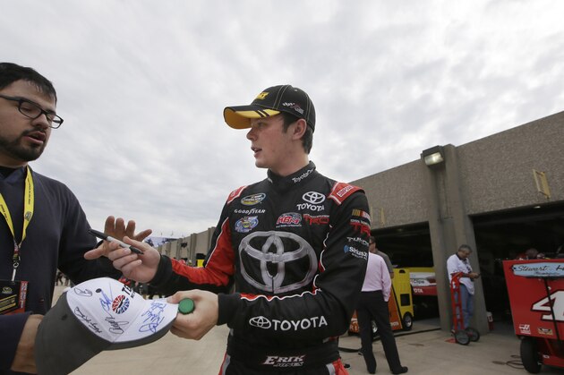 Erik Jones signs an autograph for a fan after a NASCAR Sprint Cup auto race practice at Texas Motor Speedway Friday, Nov. 6, 2015, in Fort Worth, Texas. Jones is filling in for the suspended Matt Kenseth. (AP Photo/LM Otero)