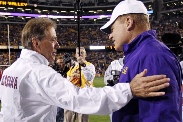Alabama head coach Nick Saban, left, greets LSU head coach Les Miles before an NCAA college football game in Baton Rouge, La., Saturday, Nov. 8, 2014. (AP Photo/Jonathan Bachman)