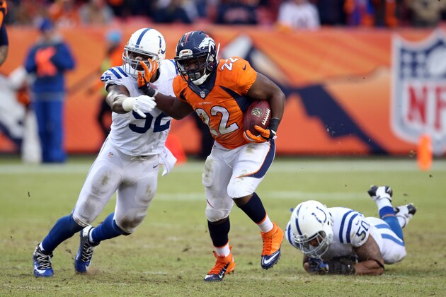 DENVER, CO - JANUARY 11: C. J. Anderson #22 of the Denver Broncos runs the ball as D'Qwell Jackson #52 defends during the game against the Indianapolis Colts during the 2015 AFC Divisional Playoff game at Sports Authority Field at Mile High on January 11, 2015 in Denver, Colorado. The Colts defeated the Broncos 24-13. (Photo by Rob Leiter/Getty Images)