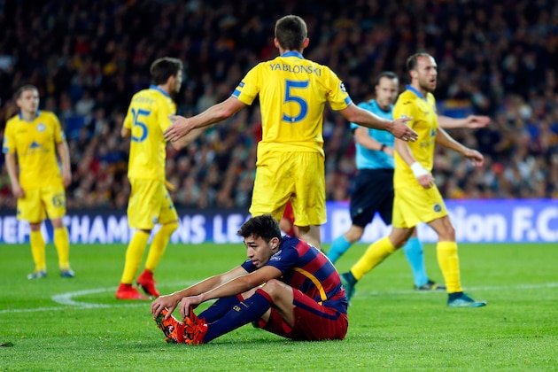 Barcelona's Munir El Haddadi stretches on the ground as Referee Istvan Vad in the background awards him a penalty shot during the Champions League Group E soccer match between FC Barcelona and BATE Borisov at the Camp Nou stadium in Barcelona, Spain, Wednesday, Nov. 4, 2015. (AP Photo/Manu Fernandez)
