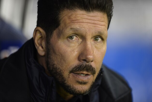Atletico Madrid's Argentinian coach Diego Simeone look on from the bench before the start of the Spanish league football match RC Deportivo La Coruna vs Club Atletico de Madrid at the Municipal de Riazor stadium in La Coruna on October 30, 2015.  The match finished with a 1-1 draw. AFP PHOTO / MIGUEL RIOPA        (Photo credit should read MIGUEL RIOPA/AFP/Getty Images)